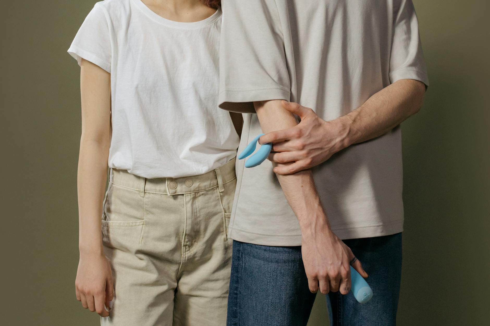 Hand holding a fresh lemon on a bright yellow background, symbolizing fresh approaches to intimate wellness